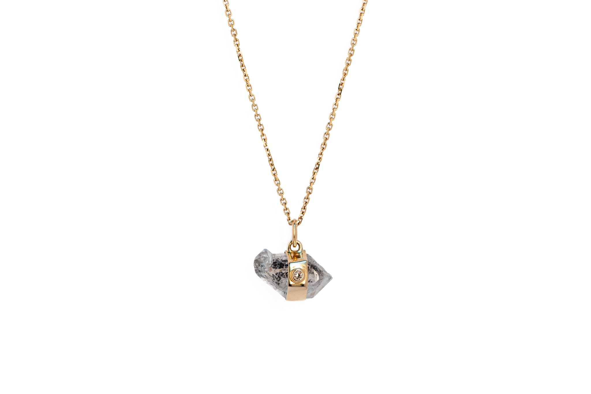 Herkimer quartz and white diamond amulet necklace on a gold chain against a white background