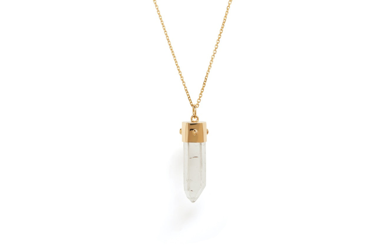The back view of the a quartz natural point, blue sapphire and orange sapphire amulet necklace on a gold chain against a white background. 