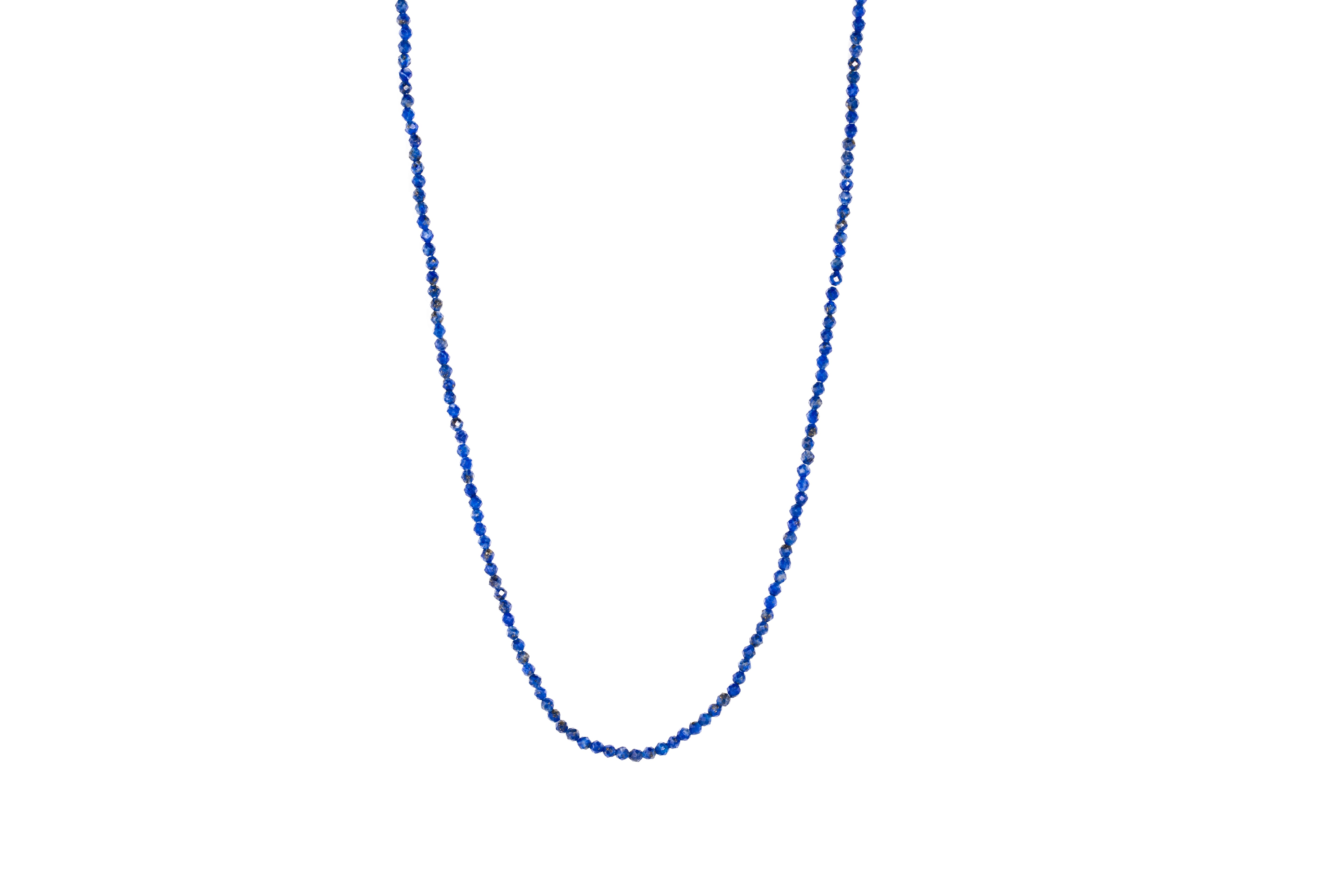 A blue lapis lazuli crystal bead necklace with an 18ct gold clasp, displayed against a white background.