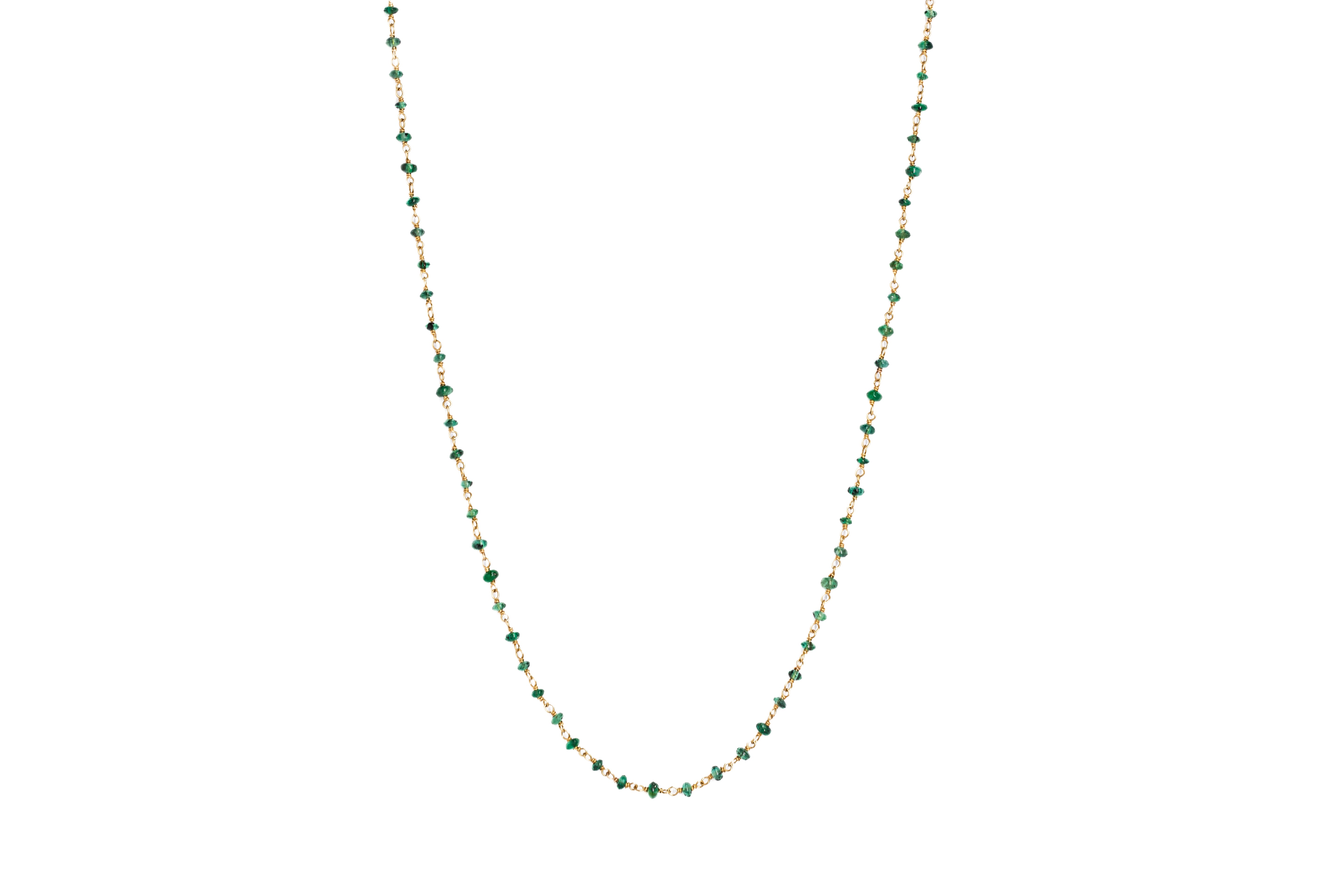 An emerald mala necklace with 108 beads, handmade with 18ct gold, displayed against a white background