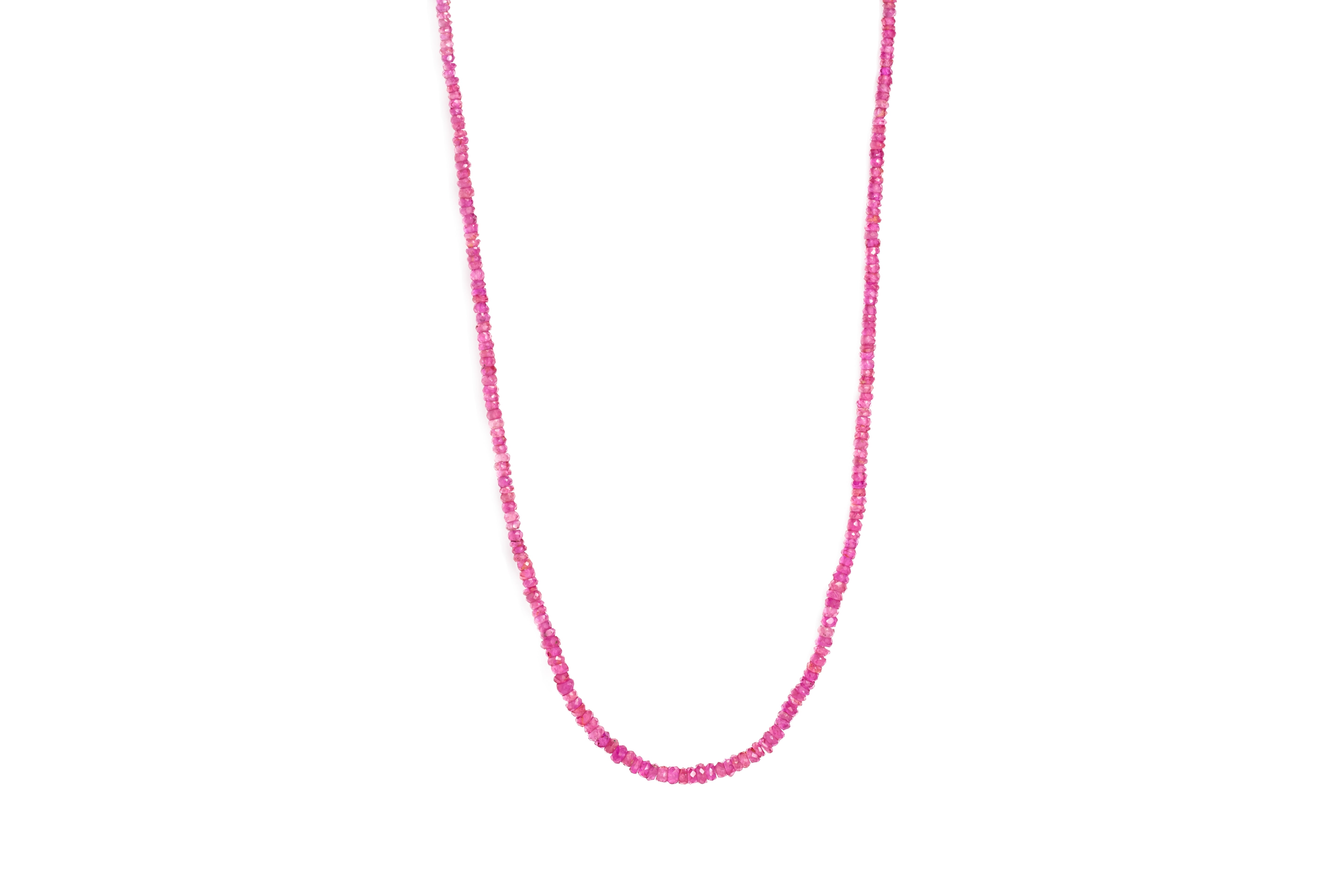 A ruby necklace with red ruby beads and an 18ct gold lobster clasp, displayed against a white background.