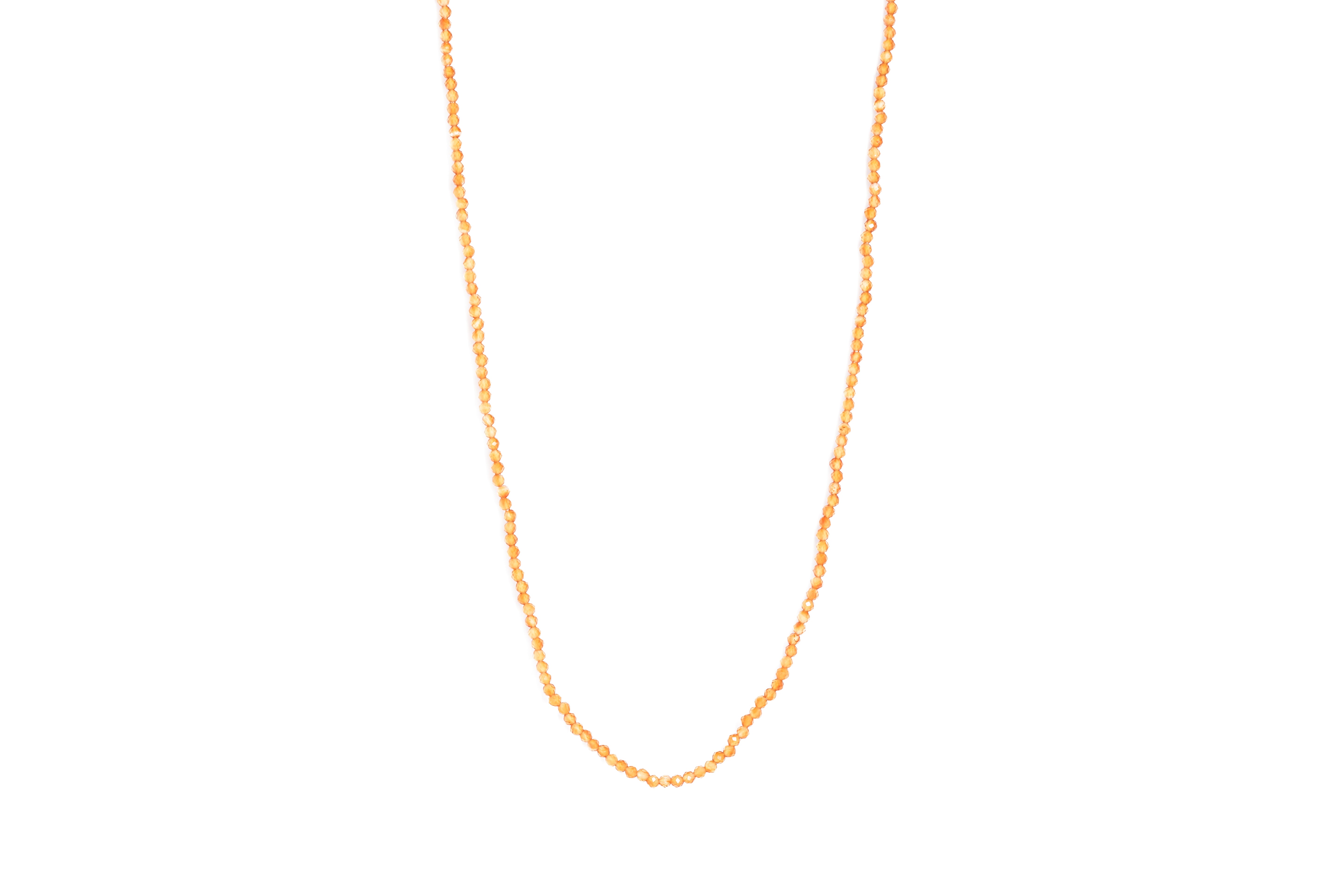 A carnelian necklace with beads against a plain white background