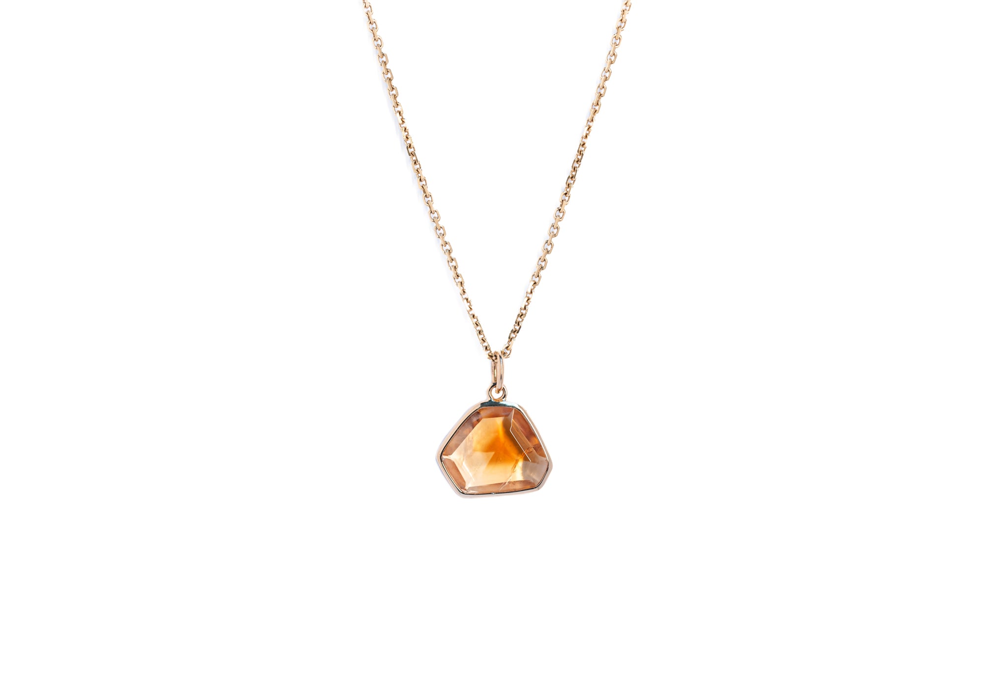 The citrine window amulet necklace 11 on a gold chain against a white background