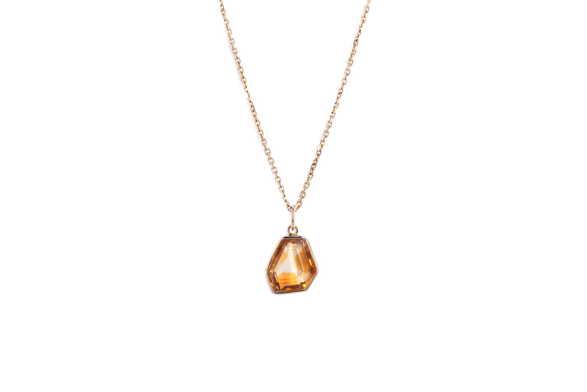 The citrine window amulet necklace 11 on a gold chain against a white background