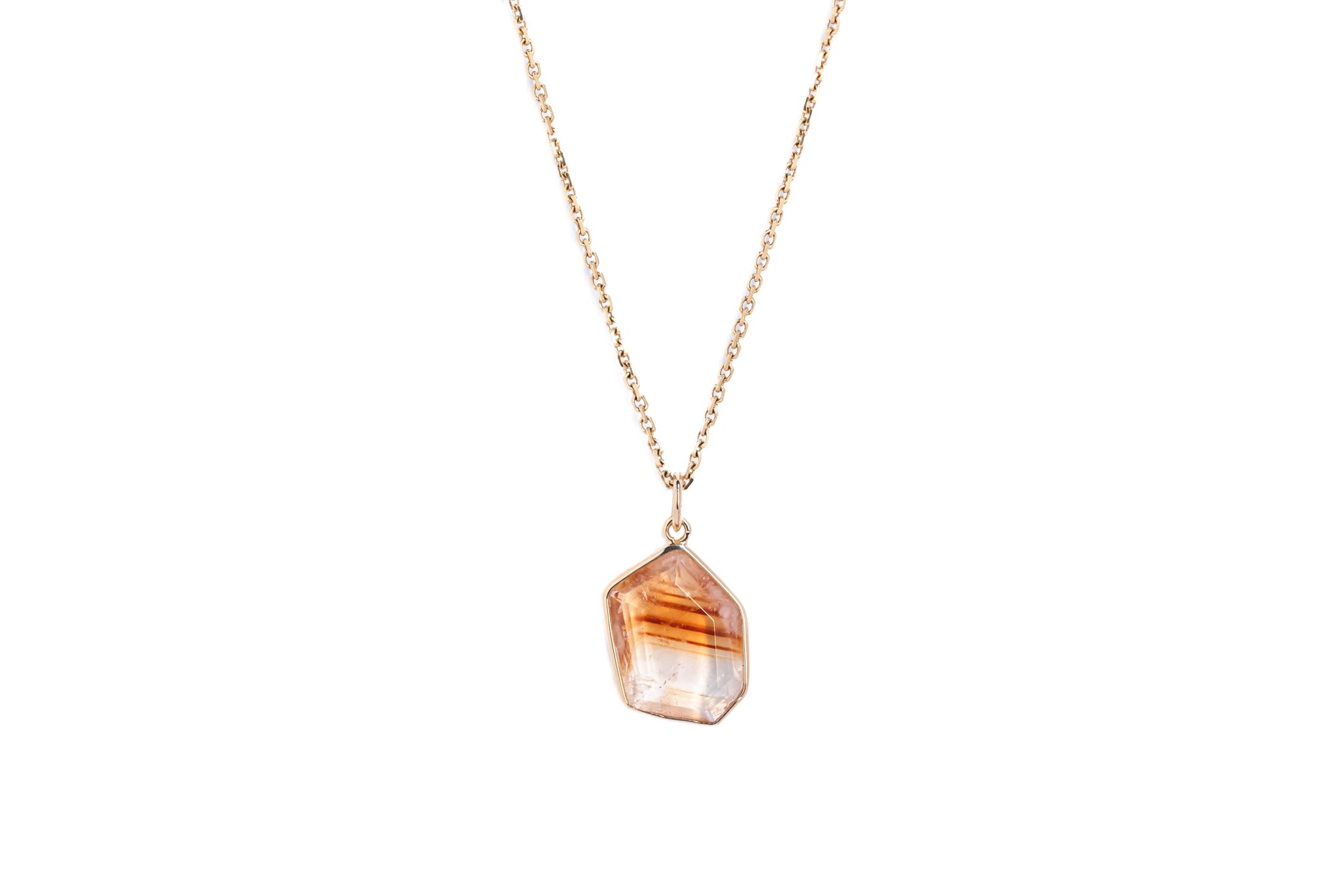 A citrine window amulet pendant with a gold-plated chain, the pendant has a faceted cut and is attached to a plain gold chain.