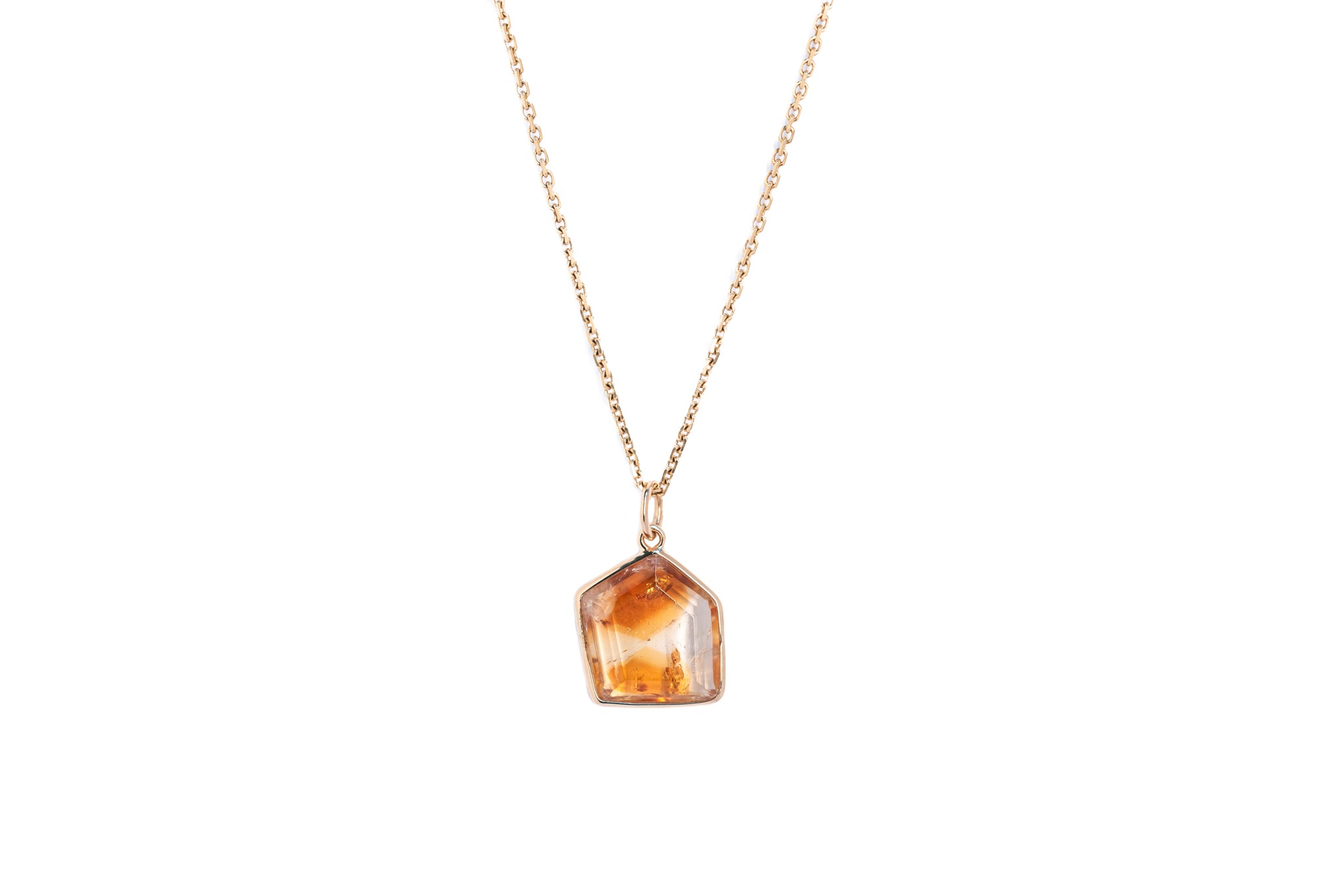 The citrine window amulet necklace 5 on a gold chain against a white background