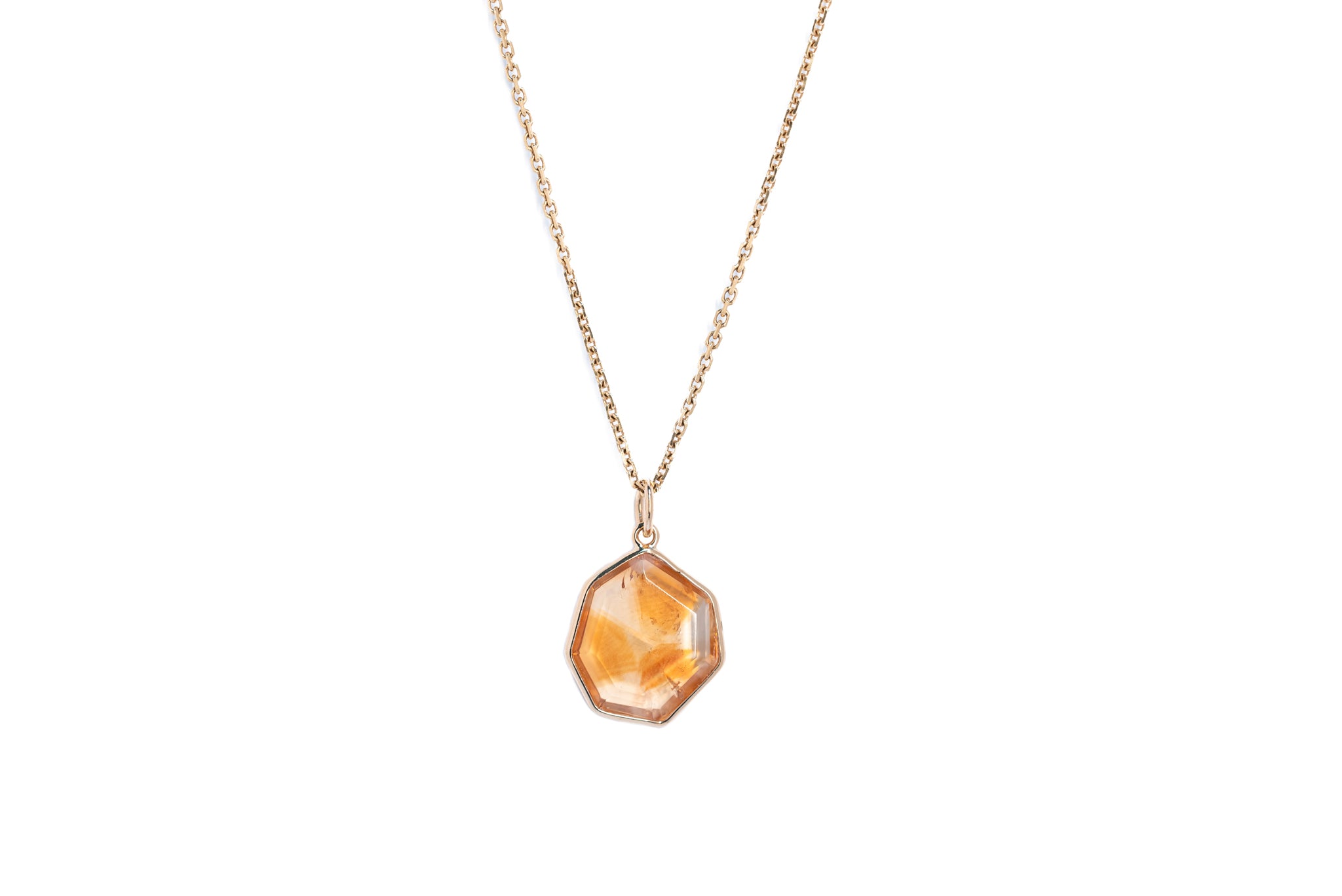 The citrine window amulet necklace 6 on a gold chain against a white background