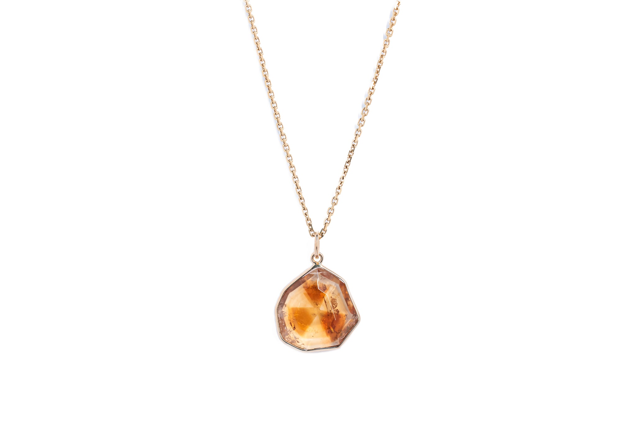 The citrine window amulet necklace 7 on a gold chain against a white background