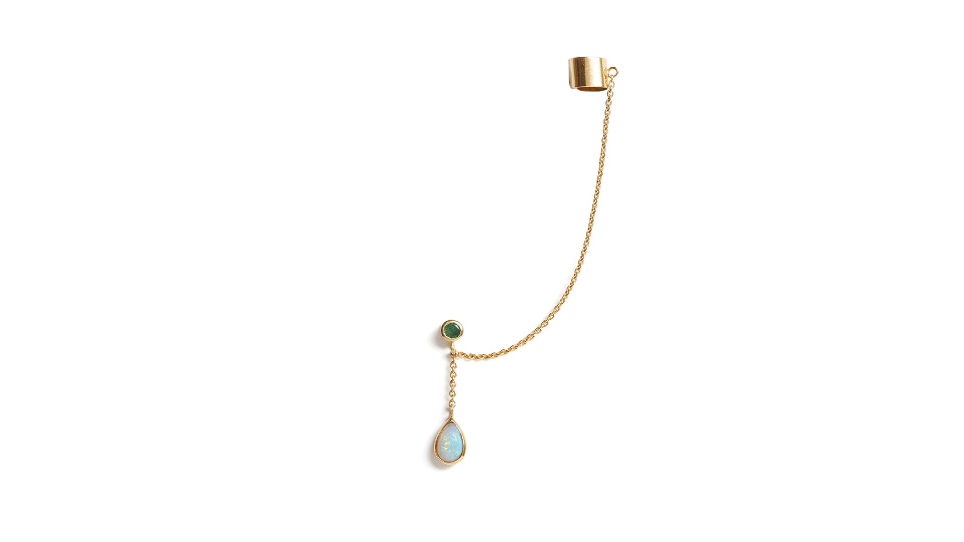 A gold ear cuff featuring an opal and an emerald stone, with a small chain link connecting the cuff to the dangle.