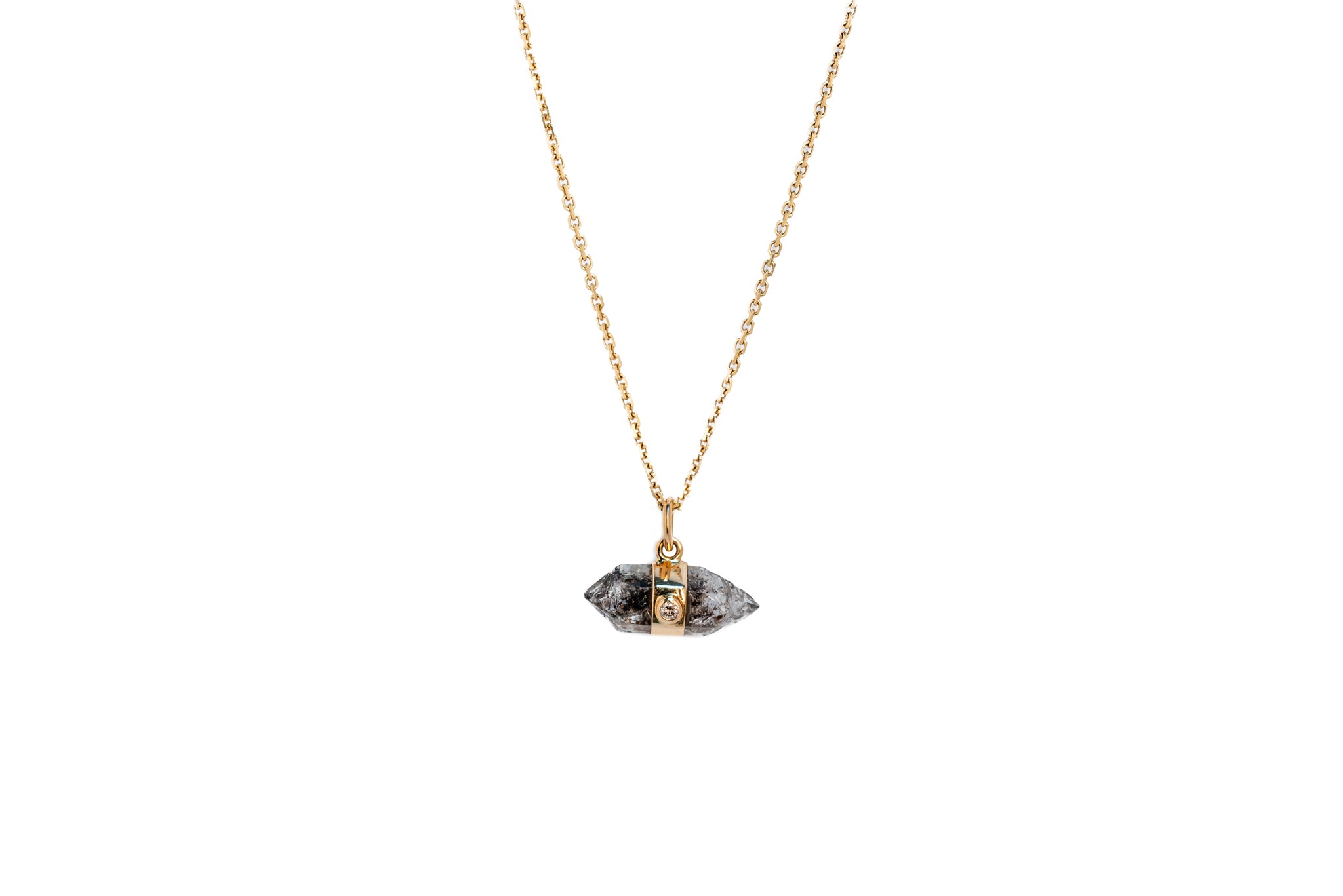 Herkimer quartz and white diamond amulet necklace on a gold chain against a white background