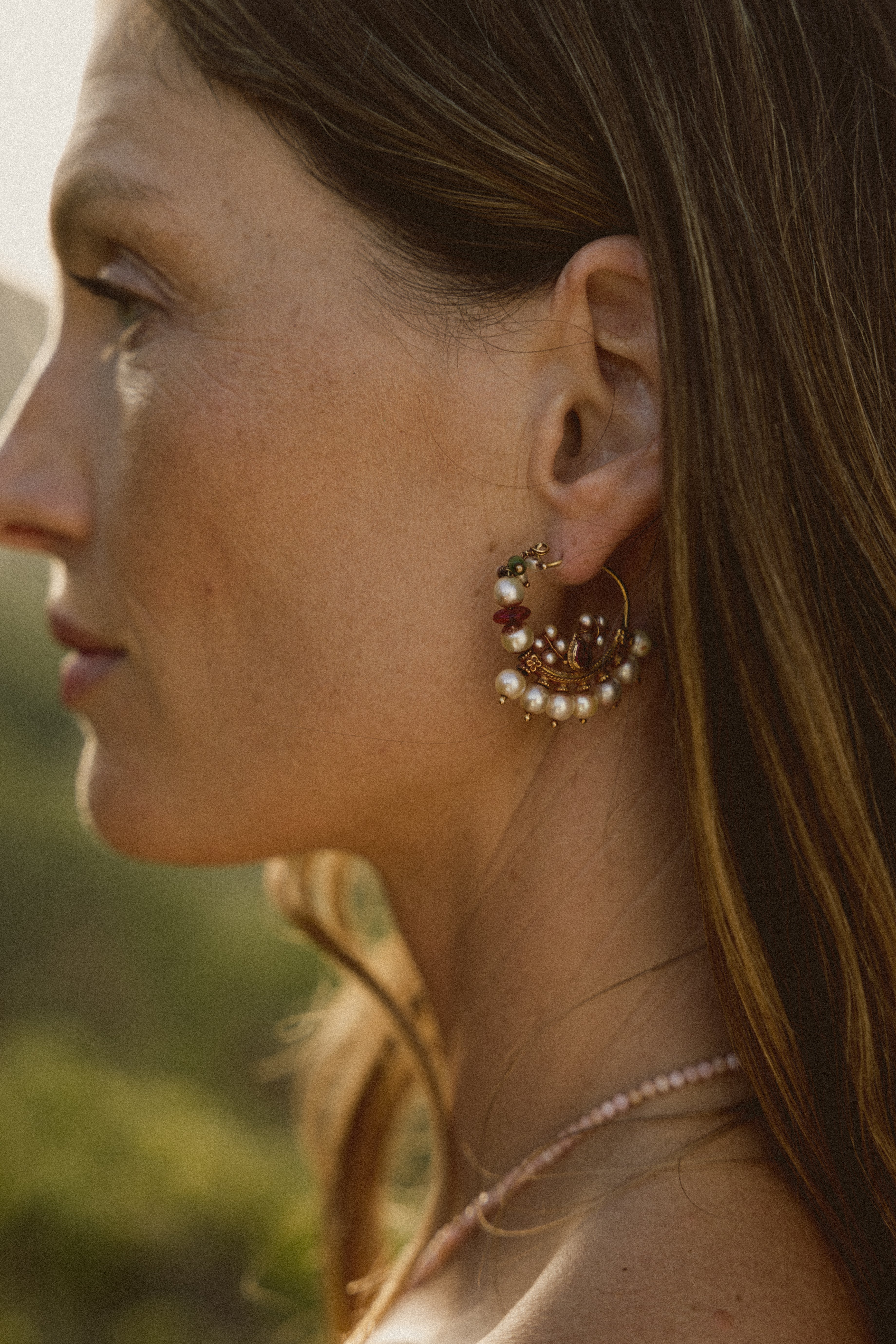 Side profile of model wearing the 'Nath' pearl gold earring