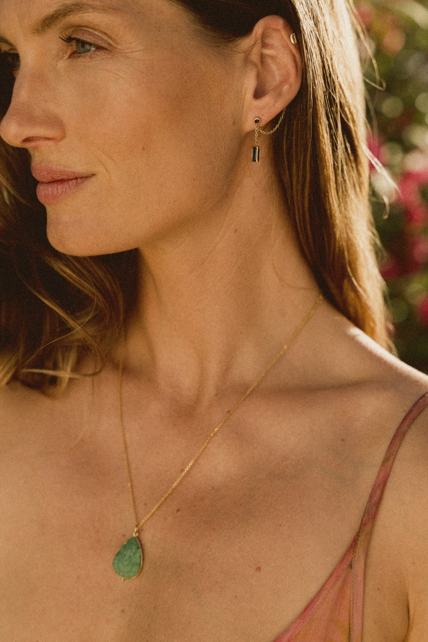 A model wearing the blue and pink tourmaline ear cuff in 18ct gold 