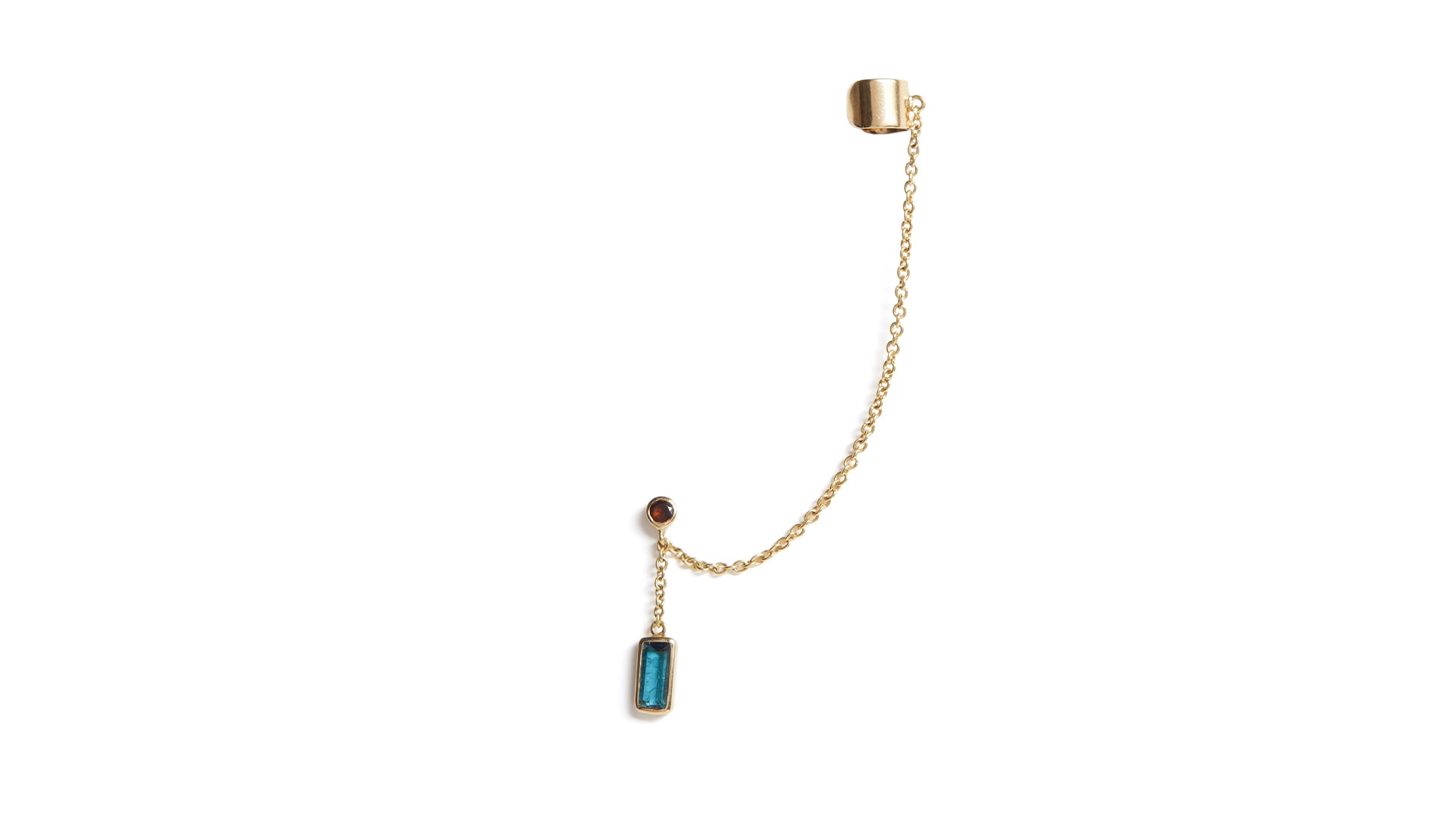 A gold ear cuff featuring a chain link with a blue and pink tourmaline stone set in a rectangular frame, isolated on a white background.