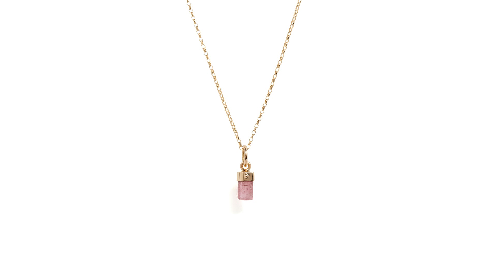A pink tourmaline baby amulet necklace with gold chain against a white background