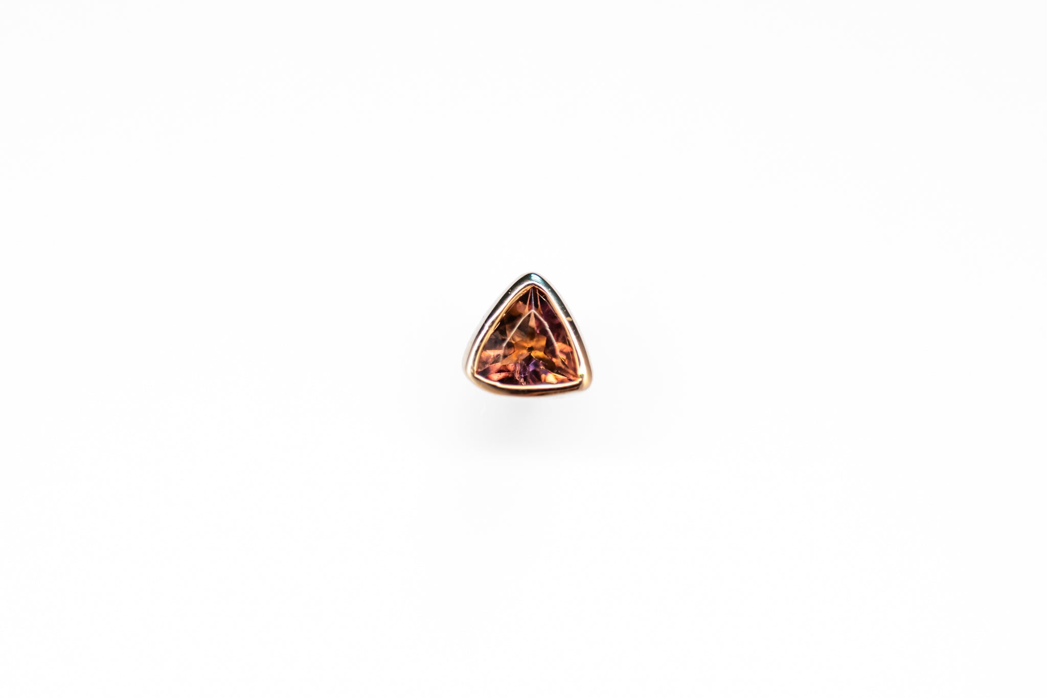 A single pink tourmaline stud earring set in 18ct gold against a white background.